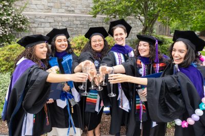 Group of graduates cheers with champagne