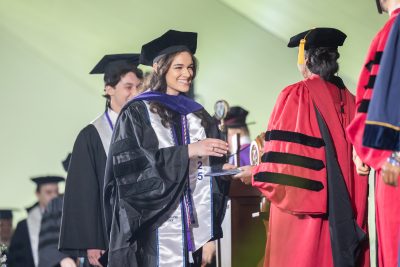 Graduate receives her diploma from dean Eboni Nelson