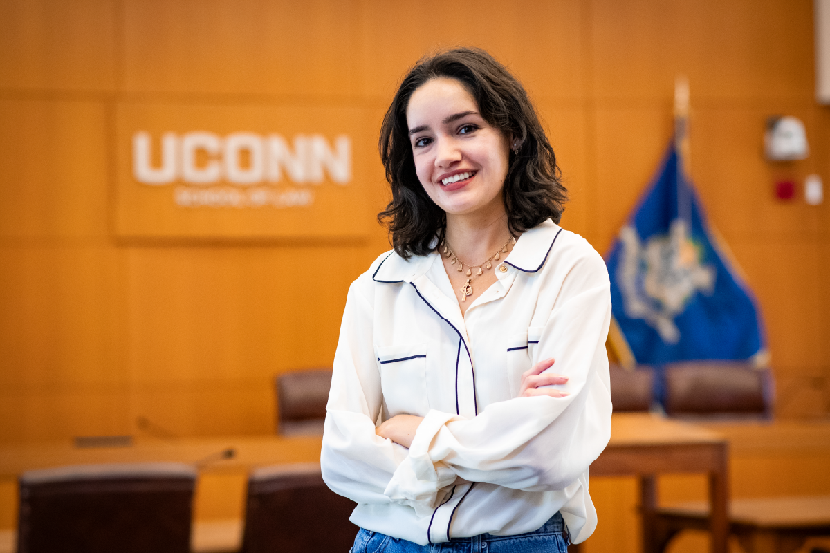 Sinéad Brennan-Gatica standing in front of UConn School of Law courtroom
